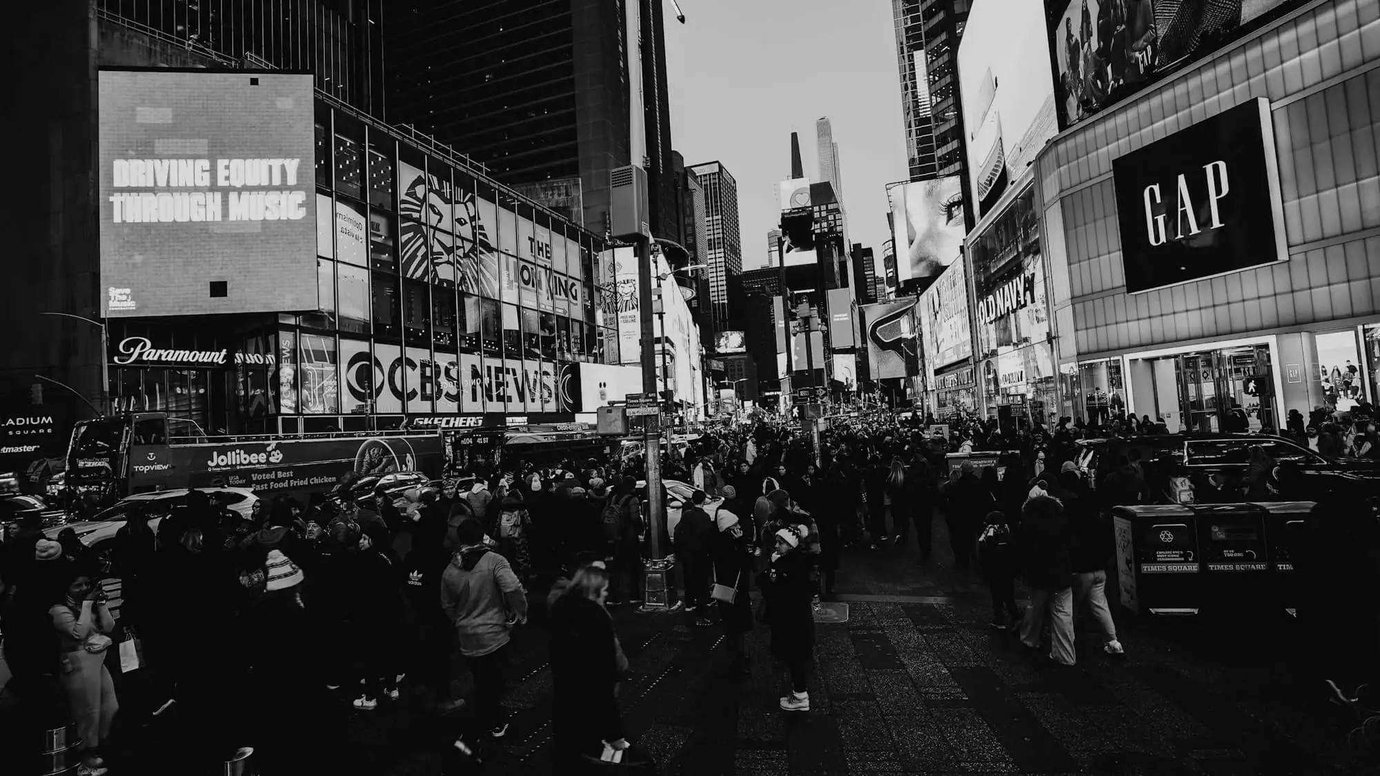 A dense crowd filling a city street, in black and white.